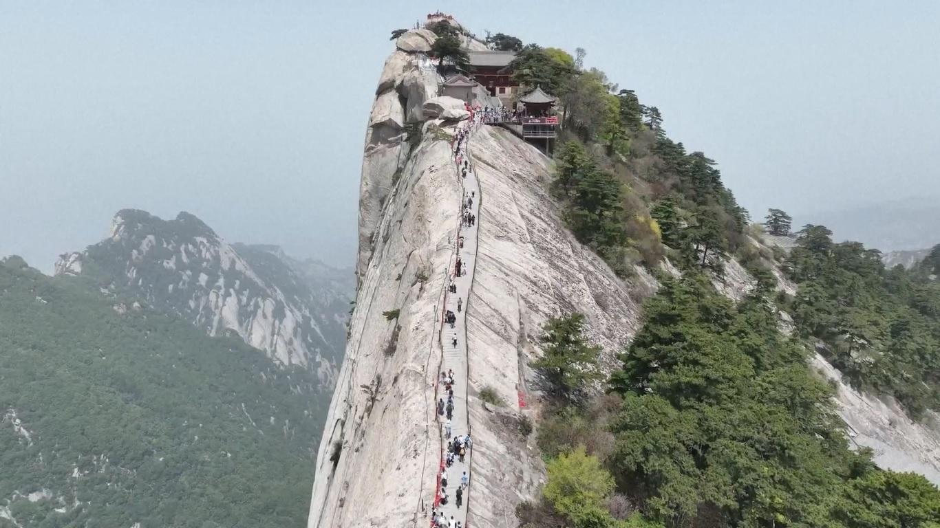 Jalur kereta gantung yang dikenal sebagai salah satu tempat paling berbahaya di dunia untuk didaki itu menggantung di ketinggian lebih dari 2100 meter di tebing Gunung Huashan